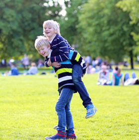Two kids playing in a park.